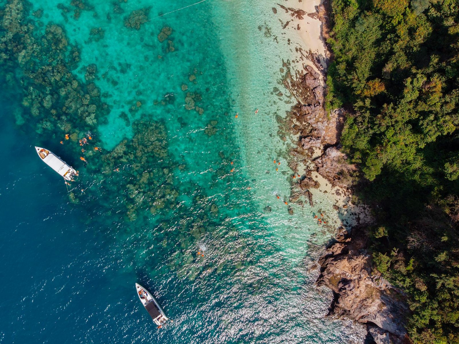 Aerial of dive boats in turquoise cove, Thailand